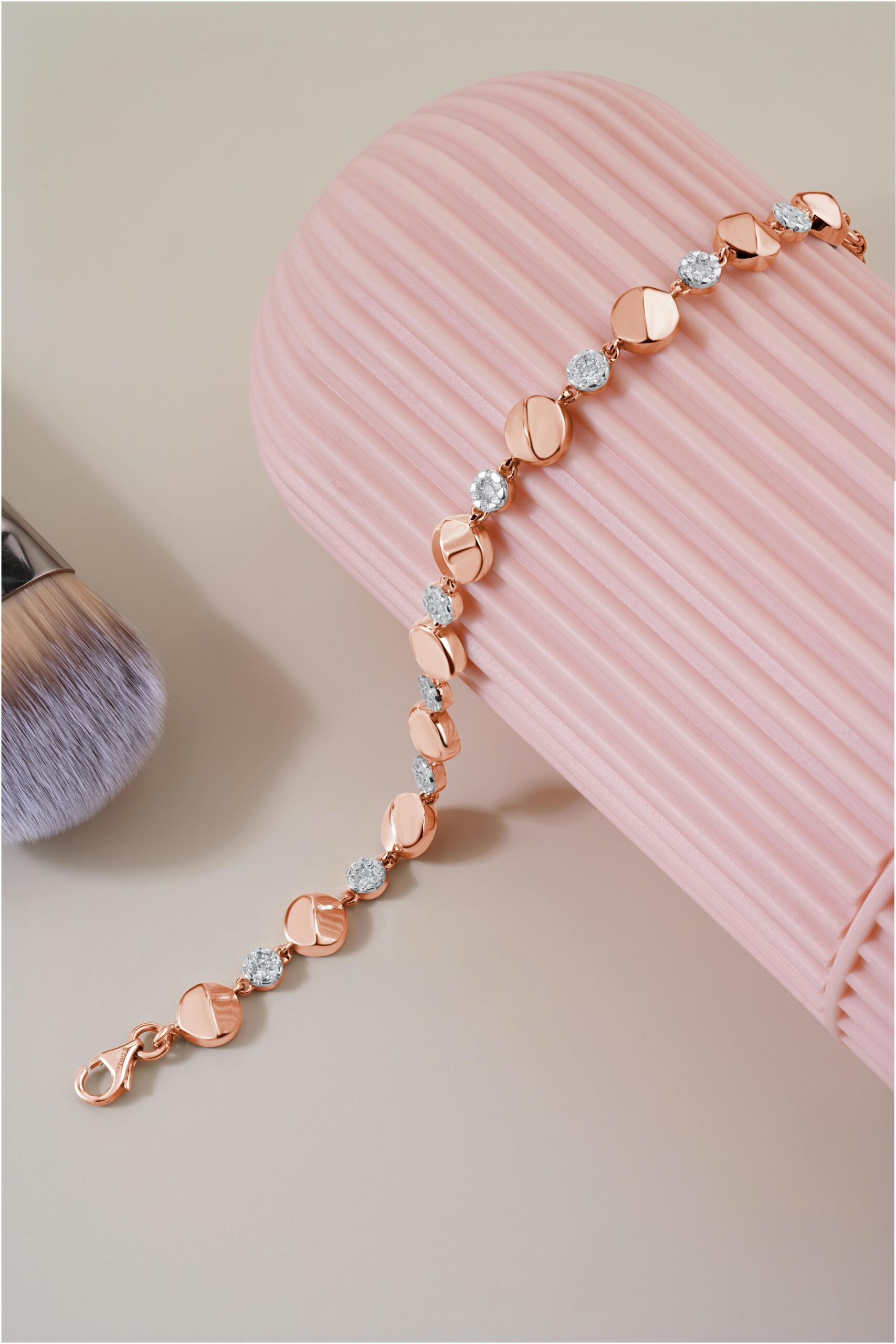 Home Stylish gold bracelet with diamonds on a pink background showcasing luxury jewelry.